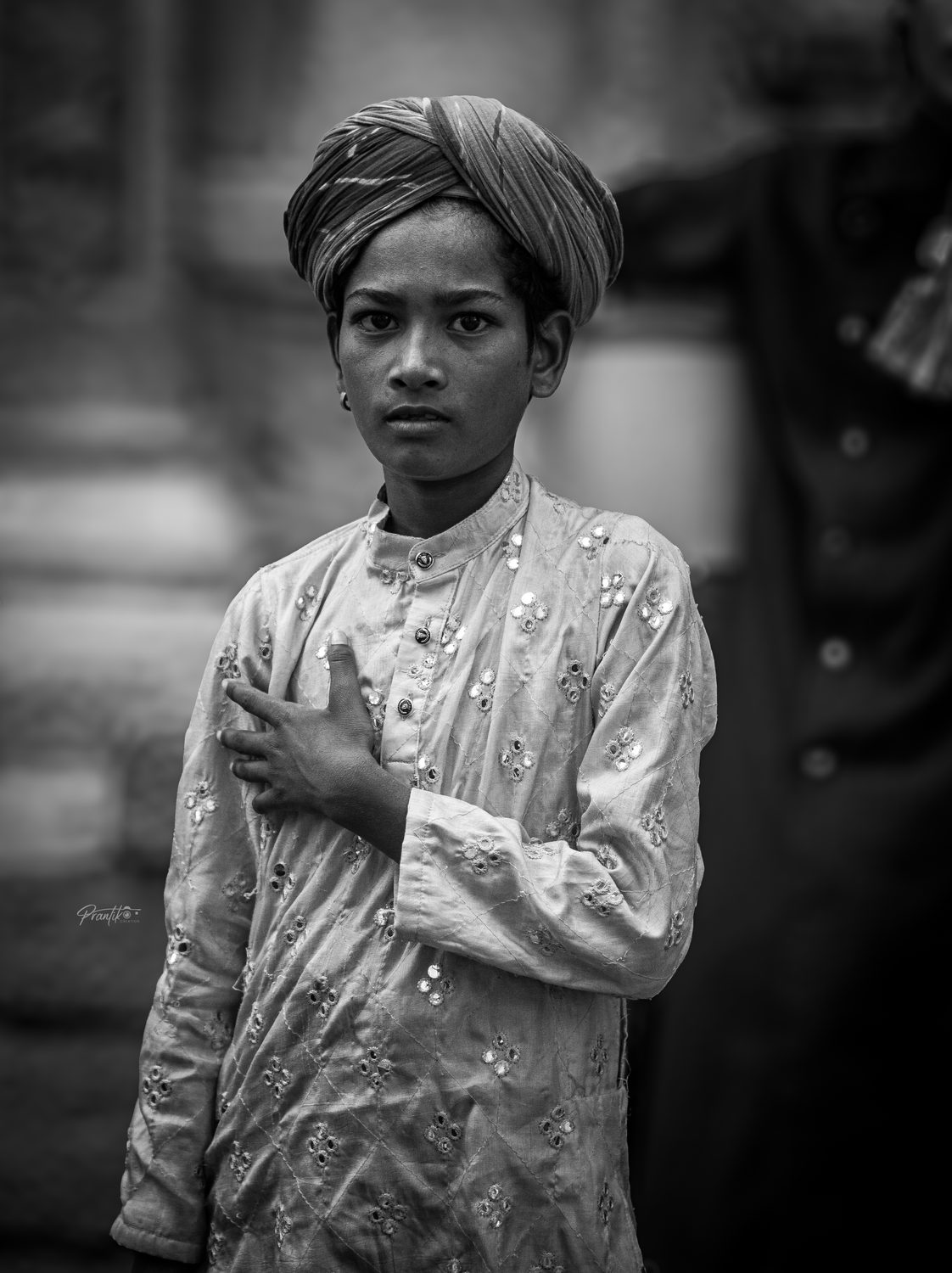 Black and white portrait of a young boy in a turban